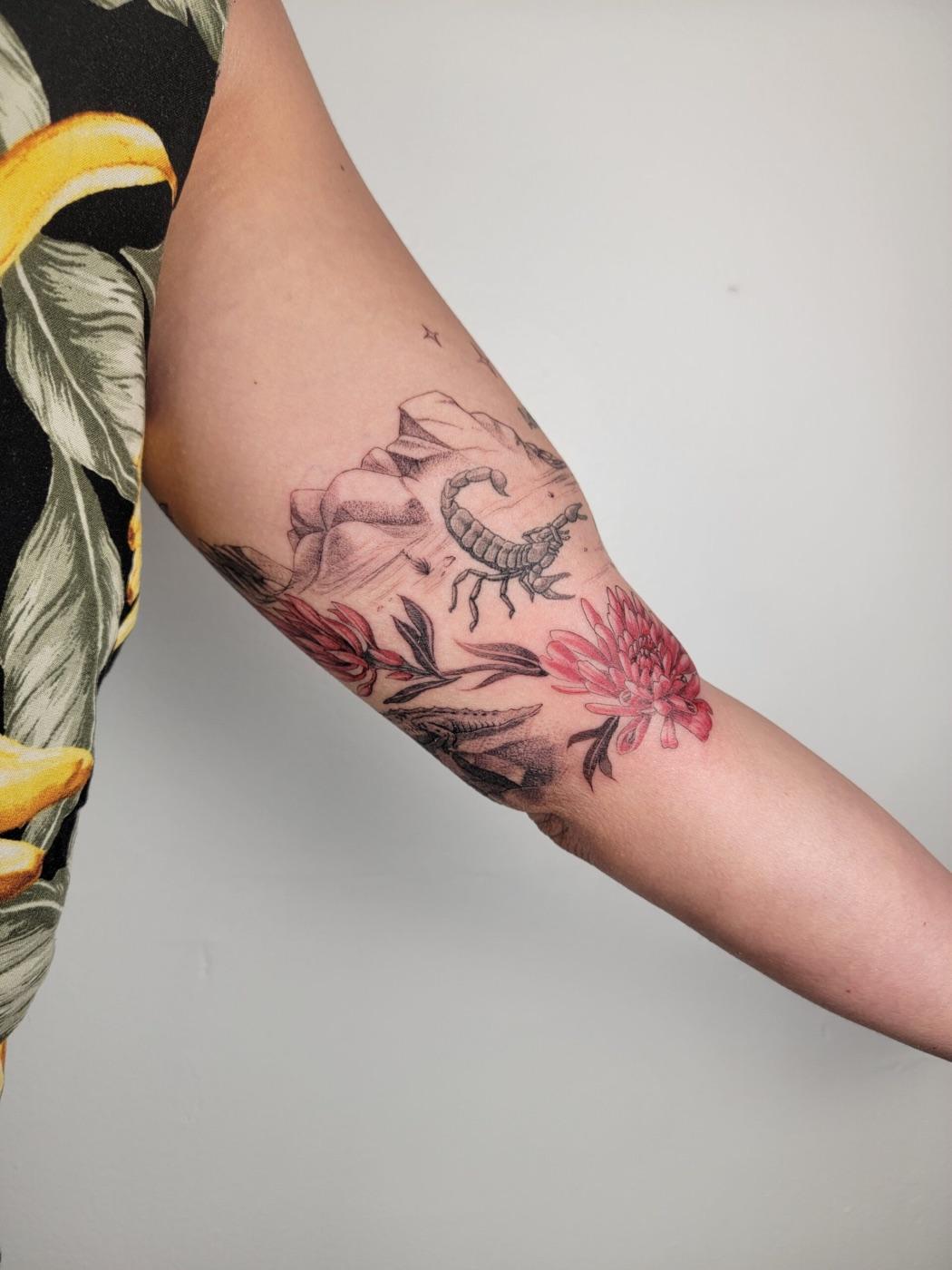 Scorpion and floral tattoo