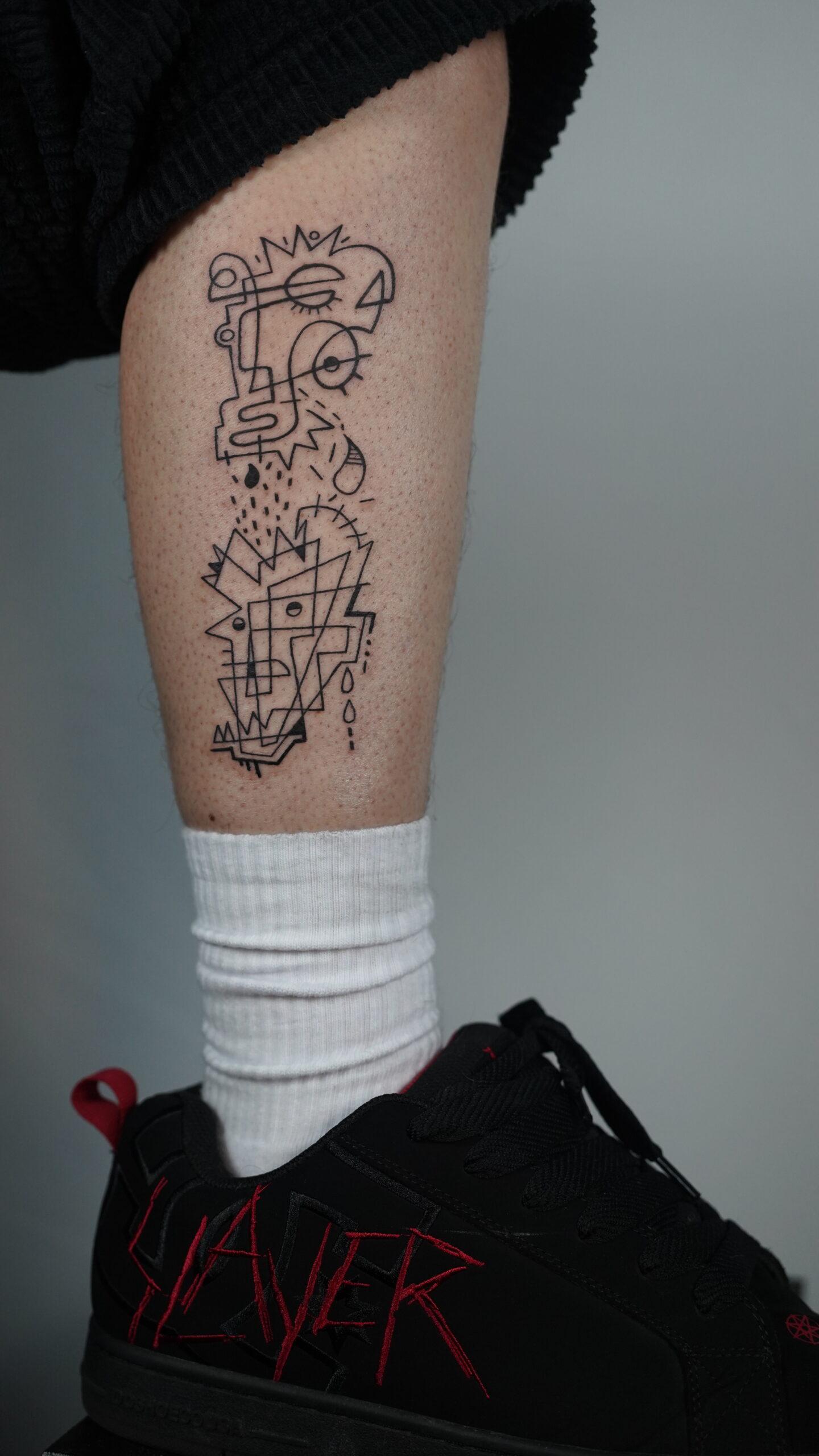 Abstract geometric face tattoo