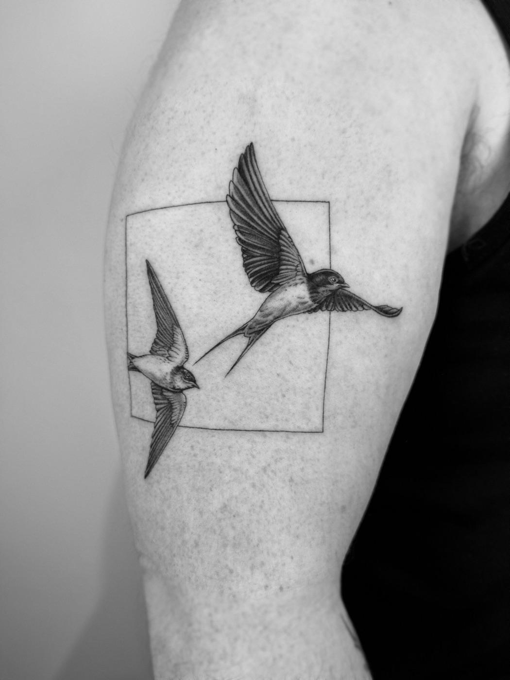Swallow and geometric tattoo