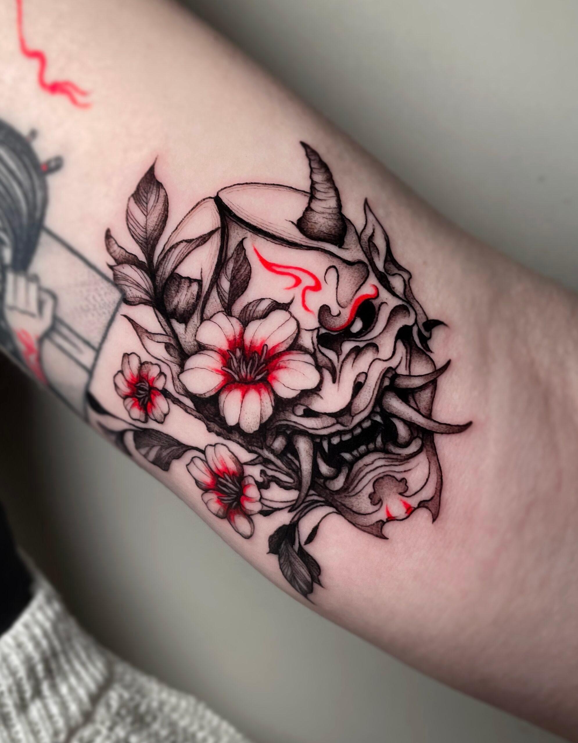 Oni mask tattoo with cherry blossoms
