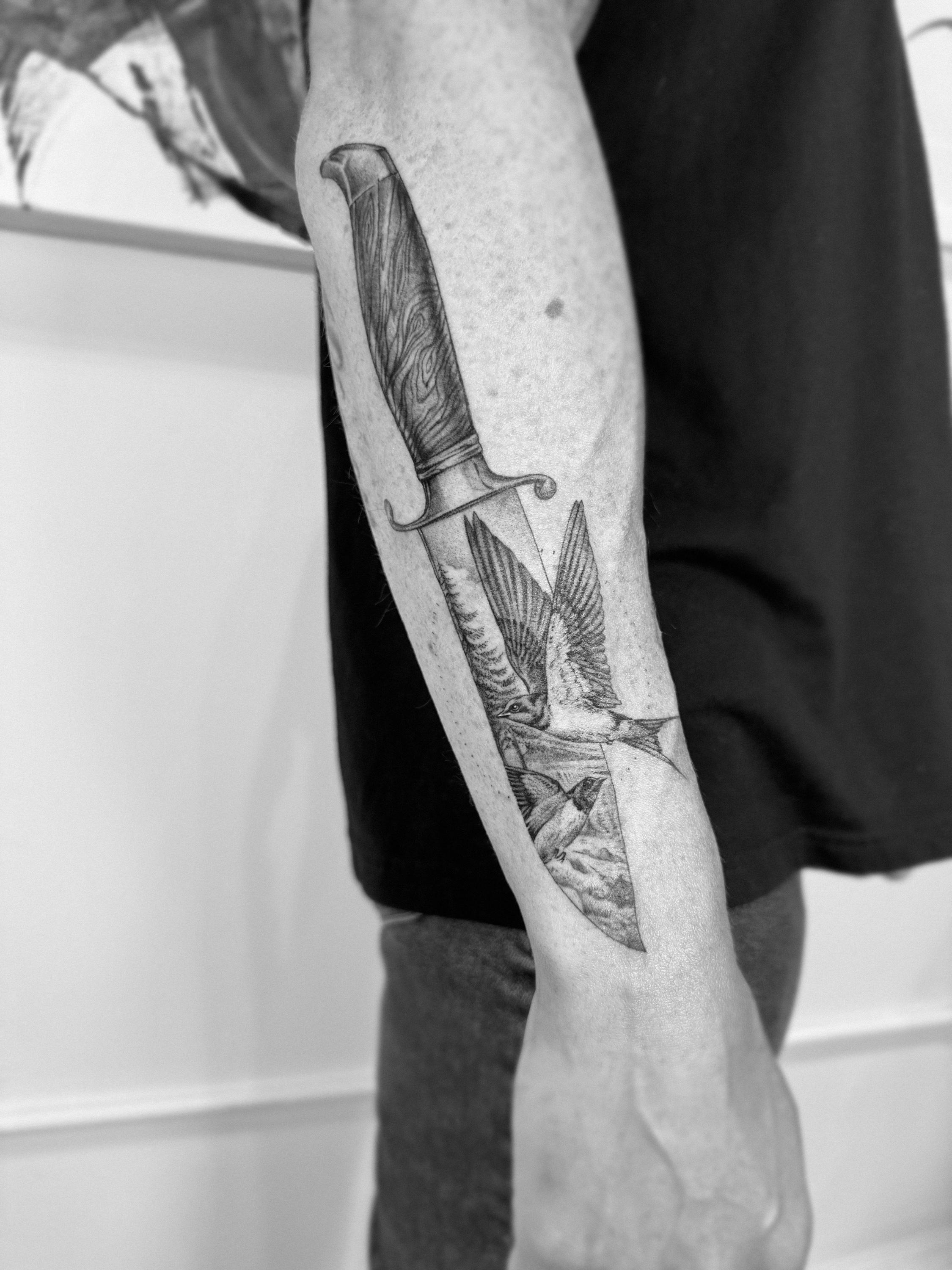 Black and grey realism dagger and bird tattoo