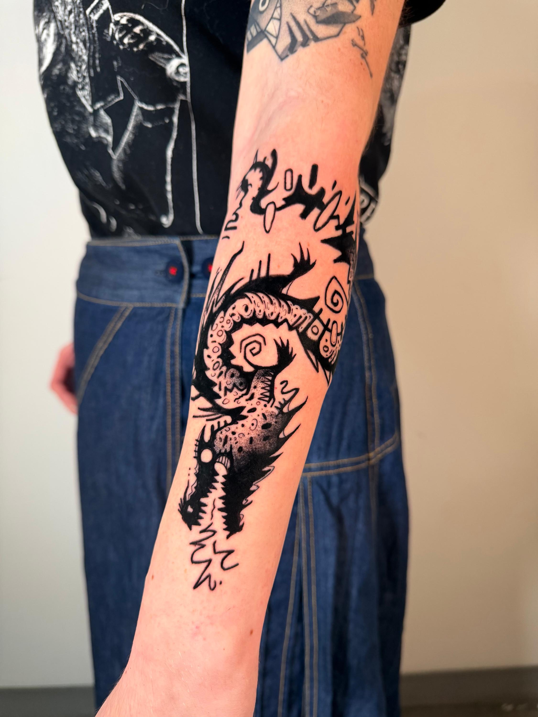 Black and grey dragon blackwork tattoo