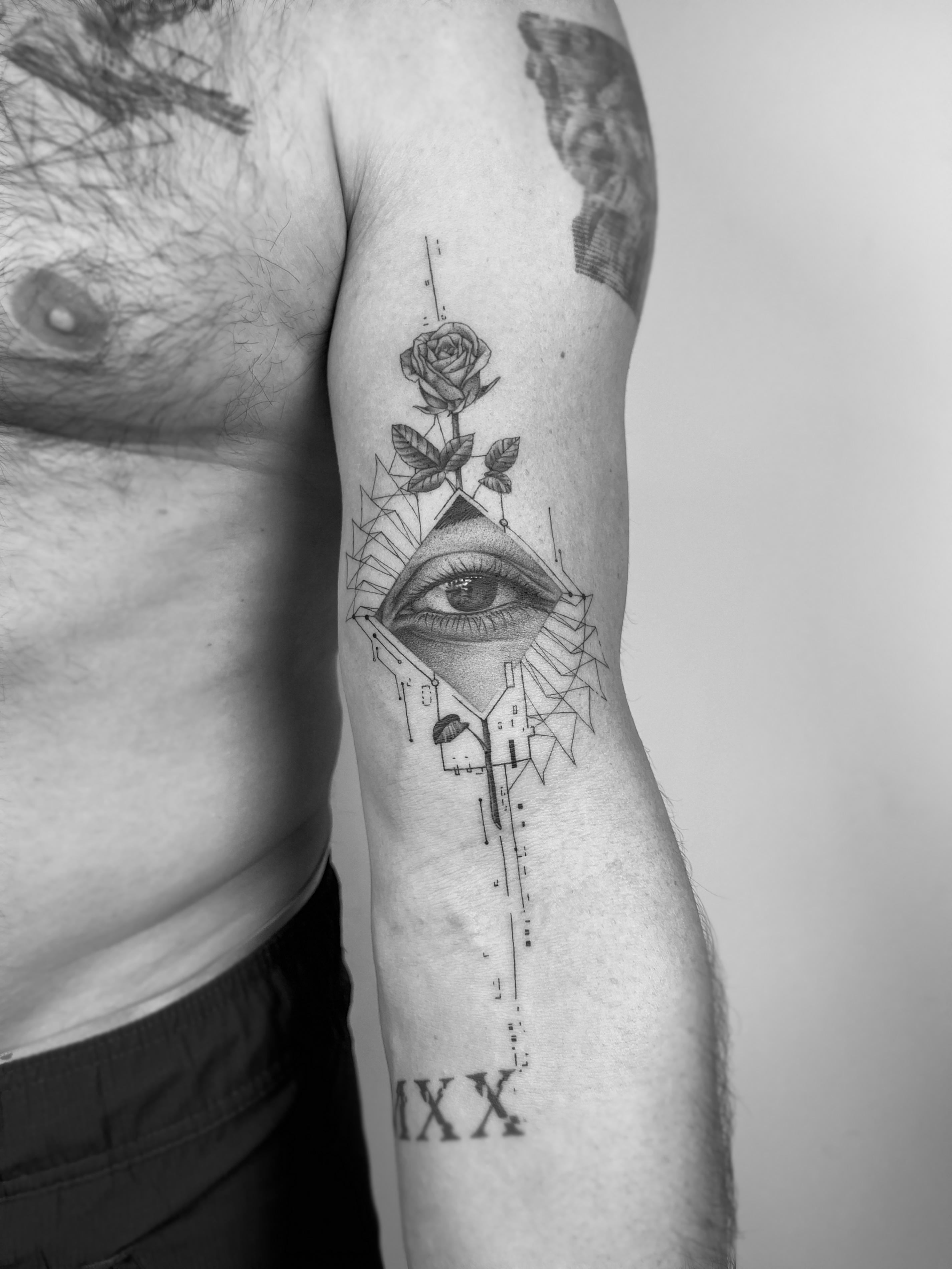 Black and grey eye and rose tattoo with geometric details