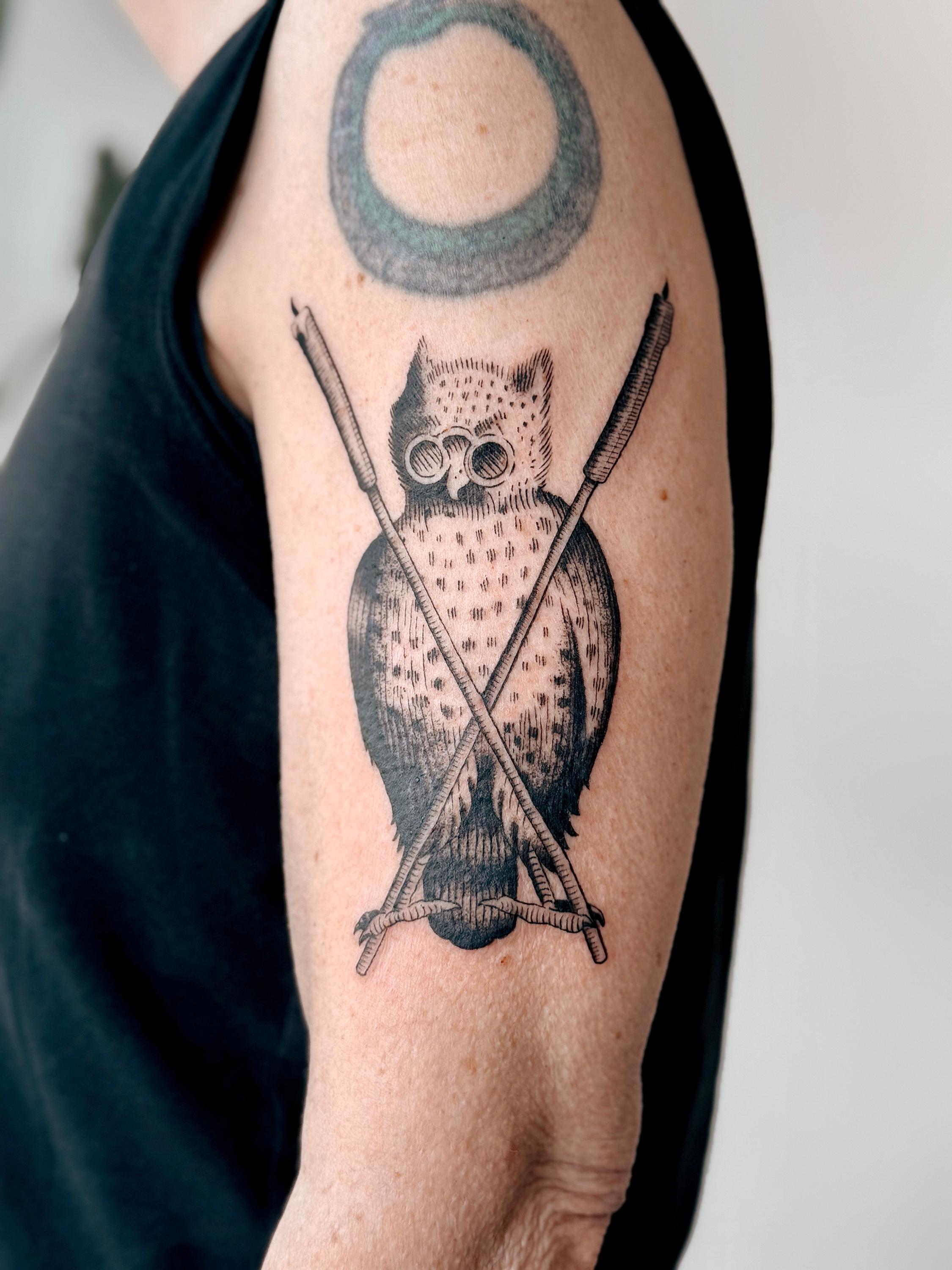 Black and grey owl and arrows tattoo
