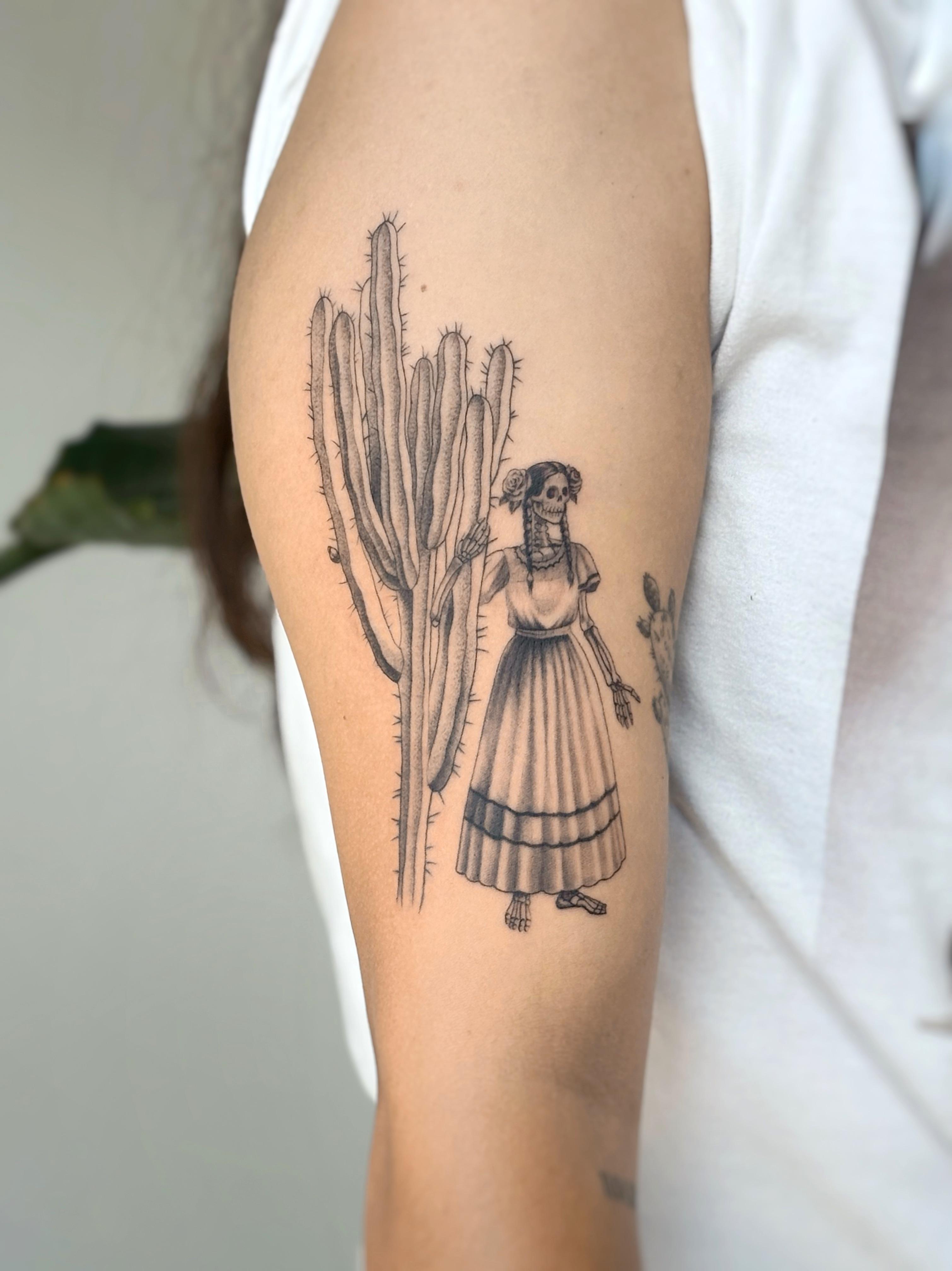 Black and grey skeleton and cactus tattoo