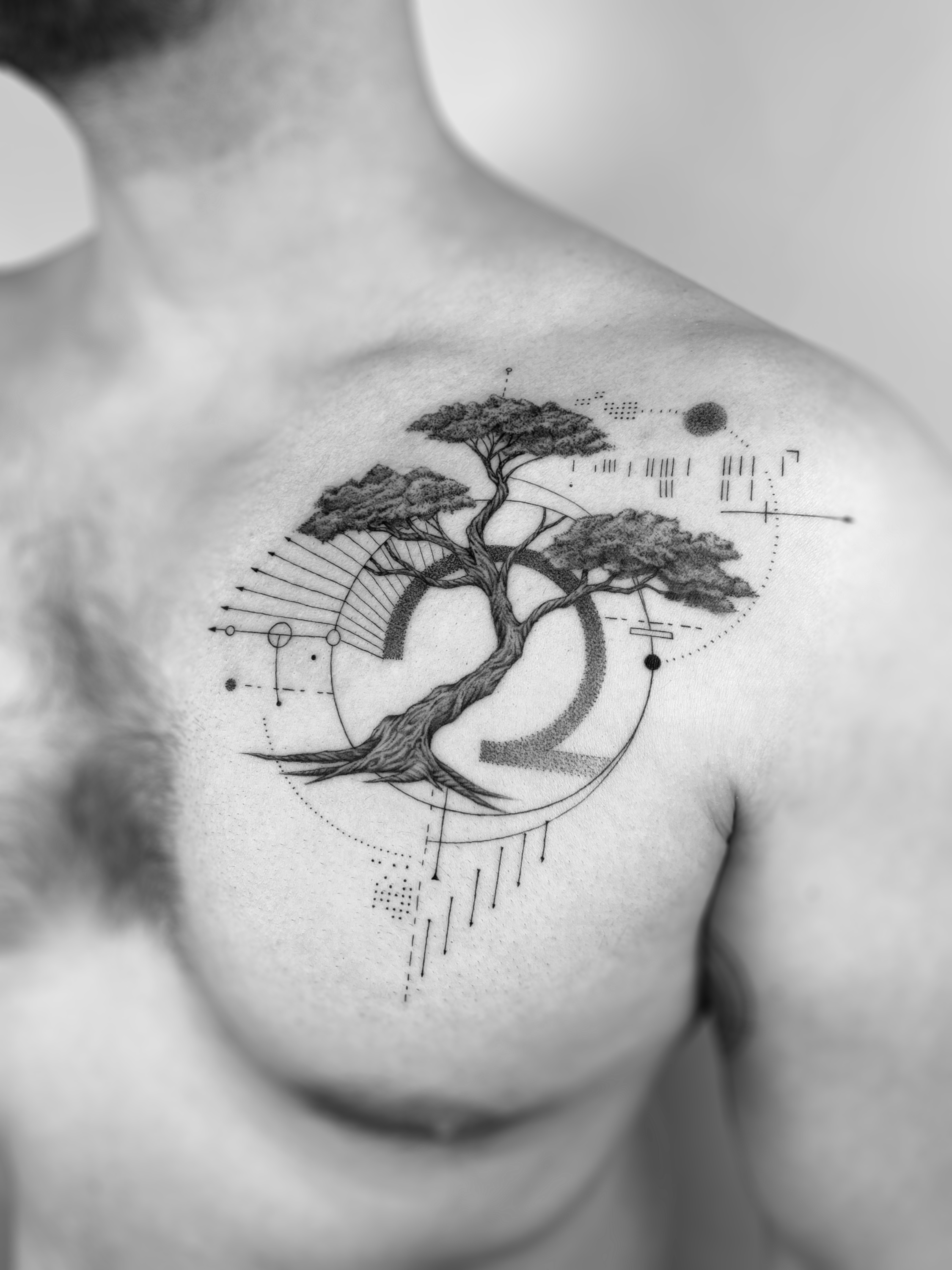 Black and grey tree tattoo with geometric linework