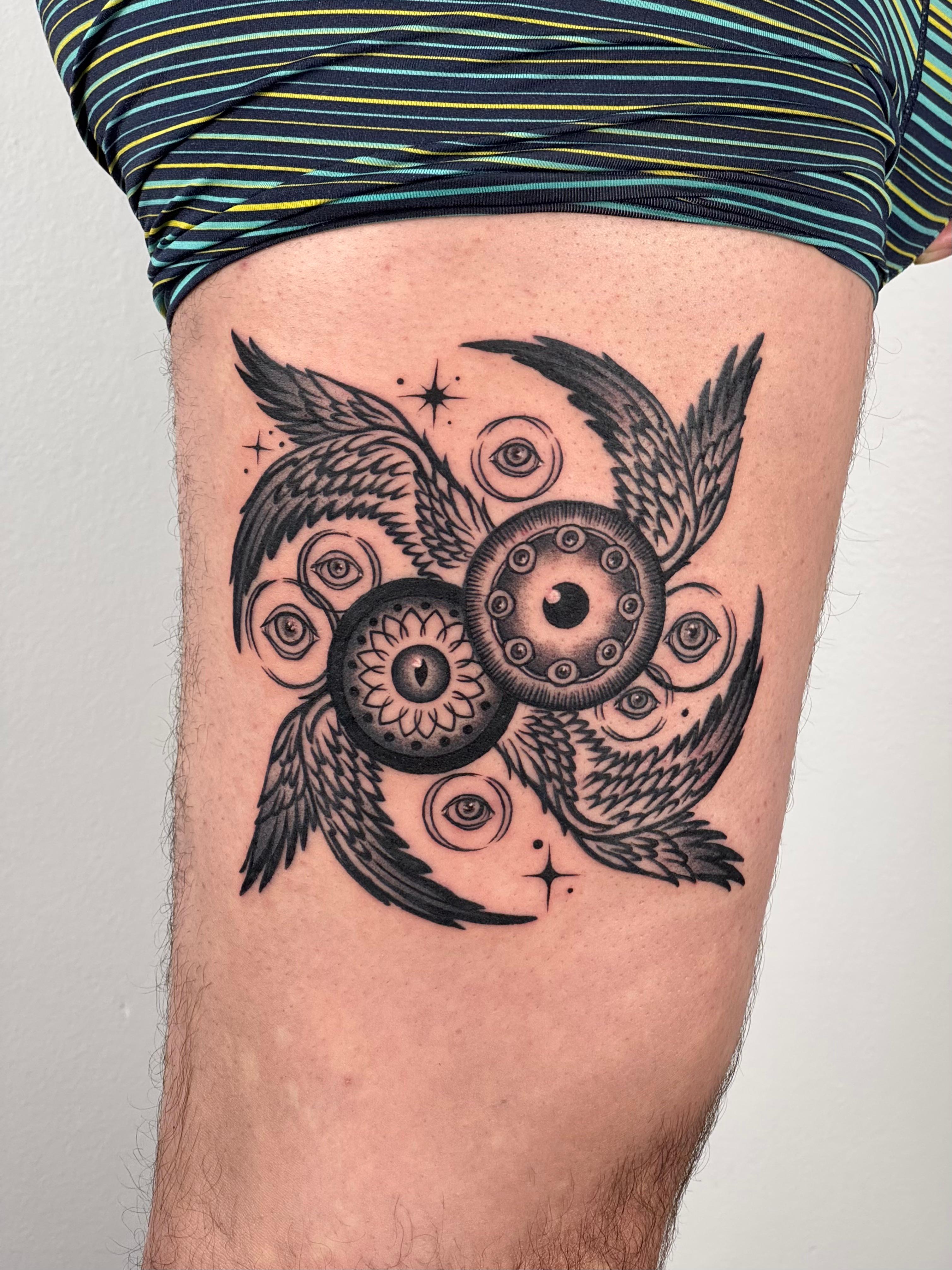 Black and grey winged eyes tattoo