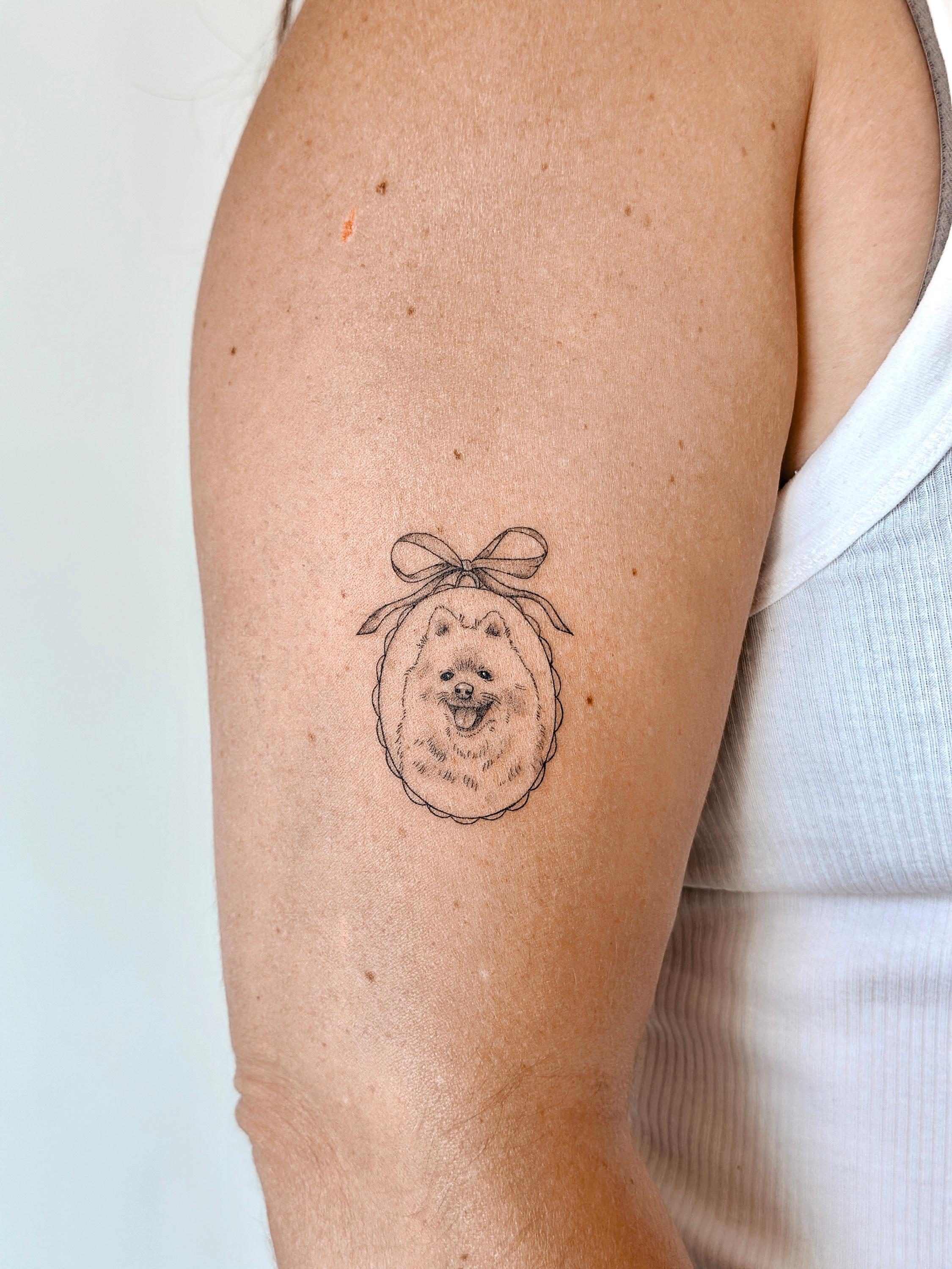 Fine line dog portrait tattoo in an oval frame