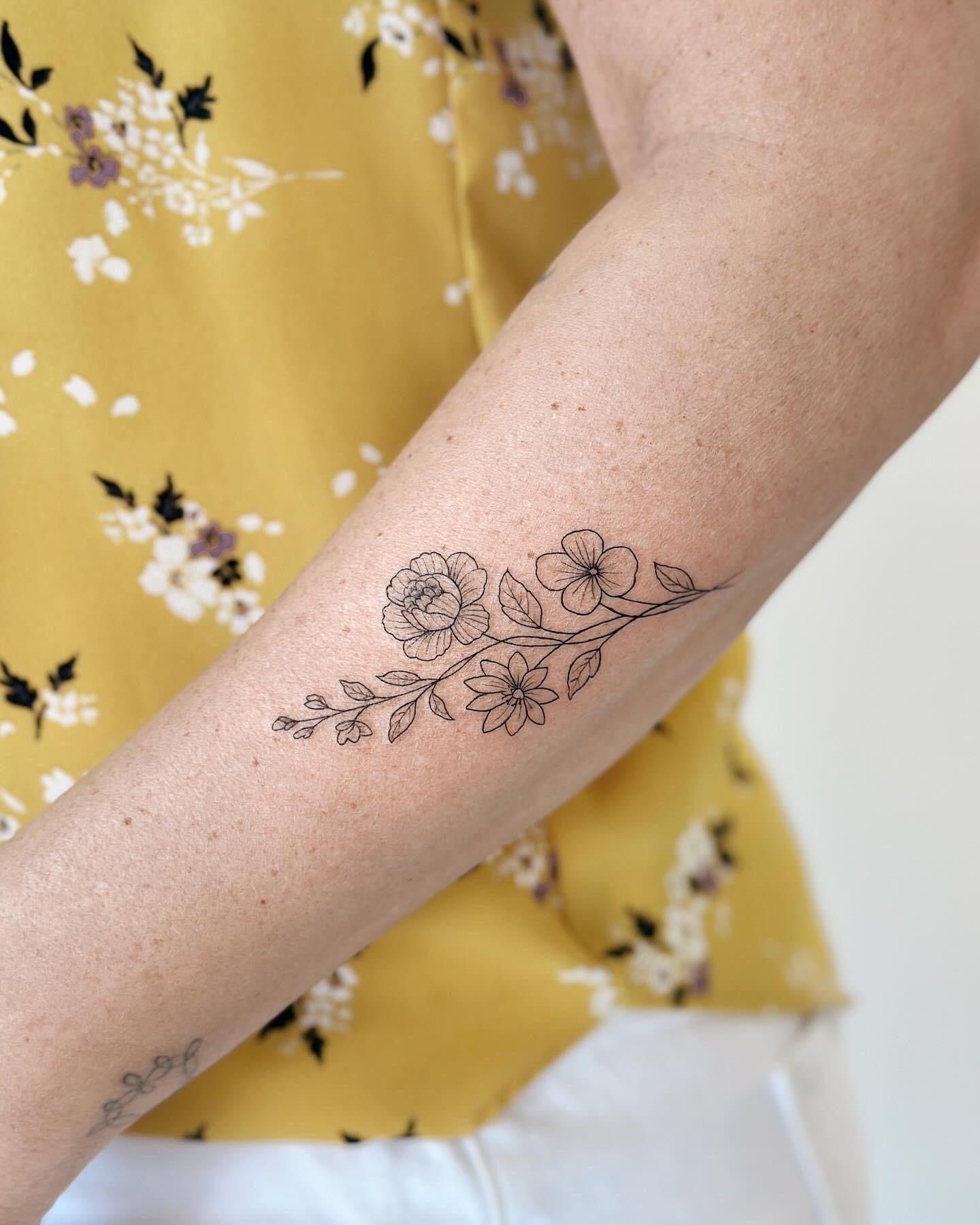 Fine line floral branch tattoo