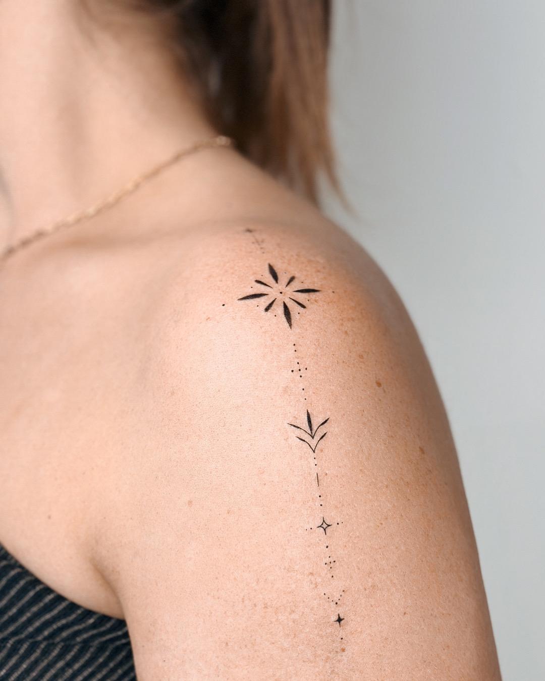 Fine line ornamental symbols tattoo