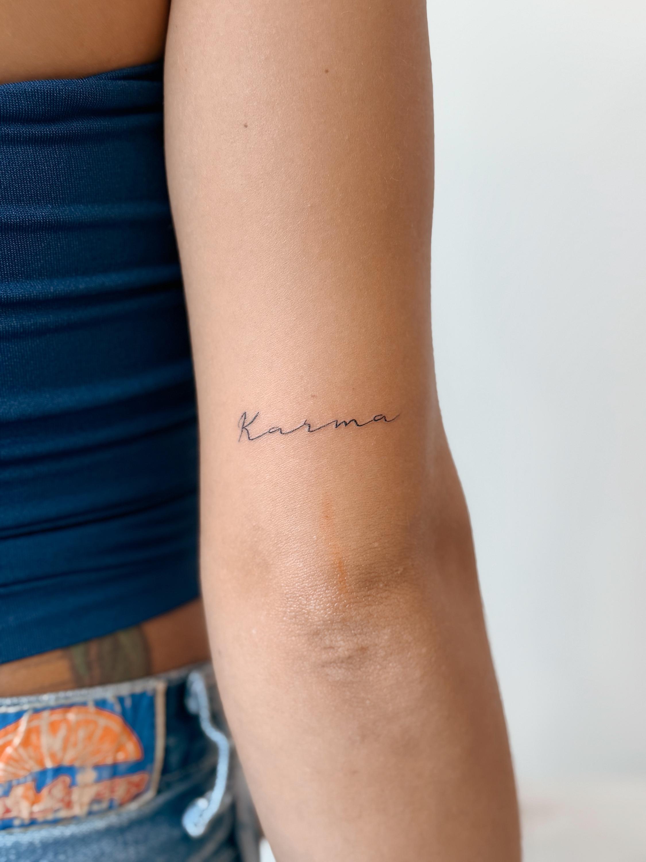 Fine line script tattoo reading Karma