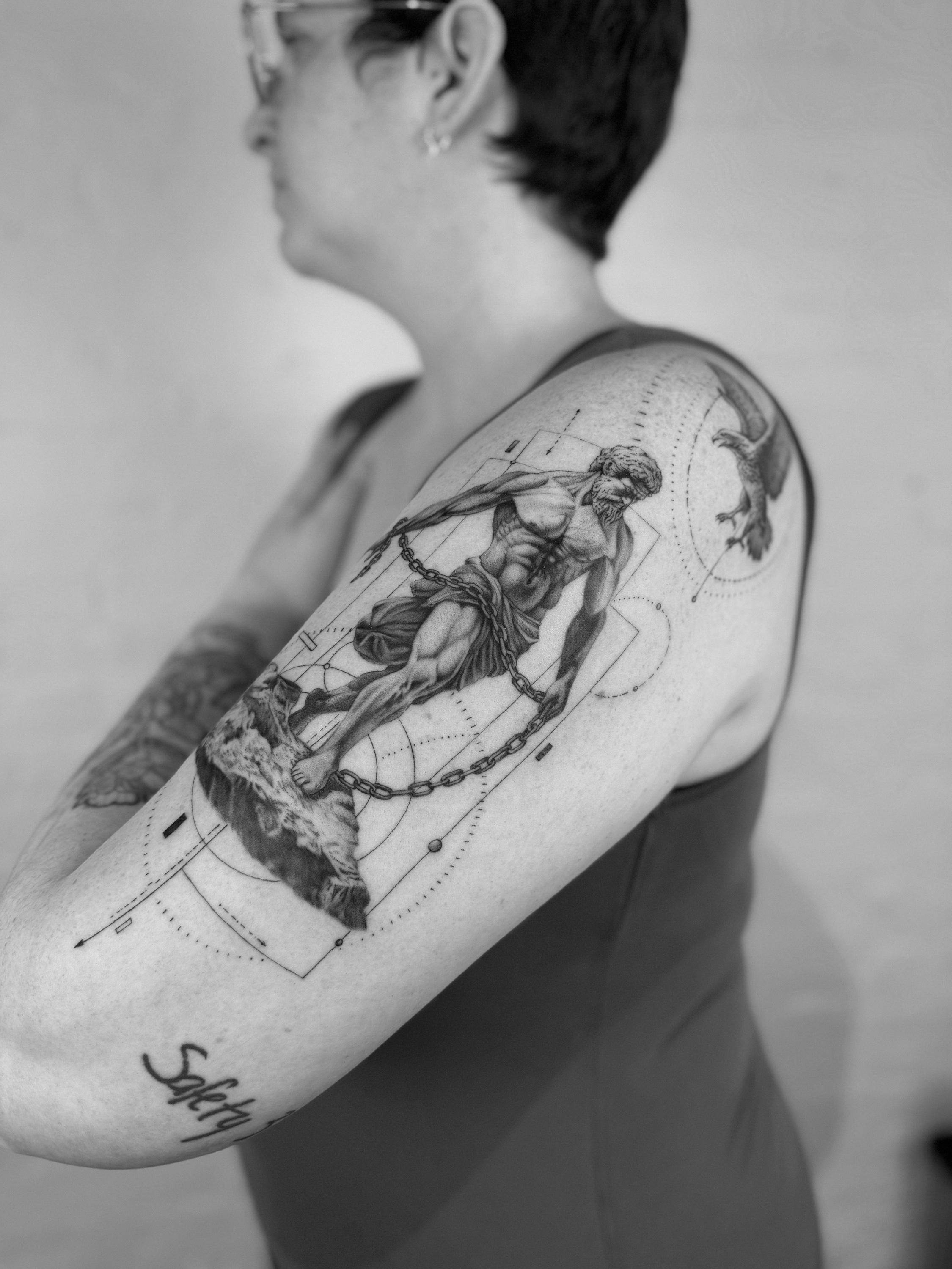 Black and grey realism chained statue tattoo
